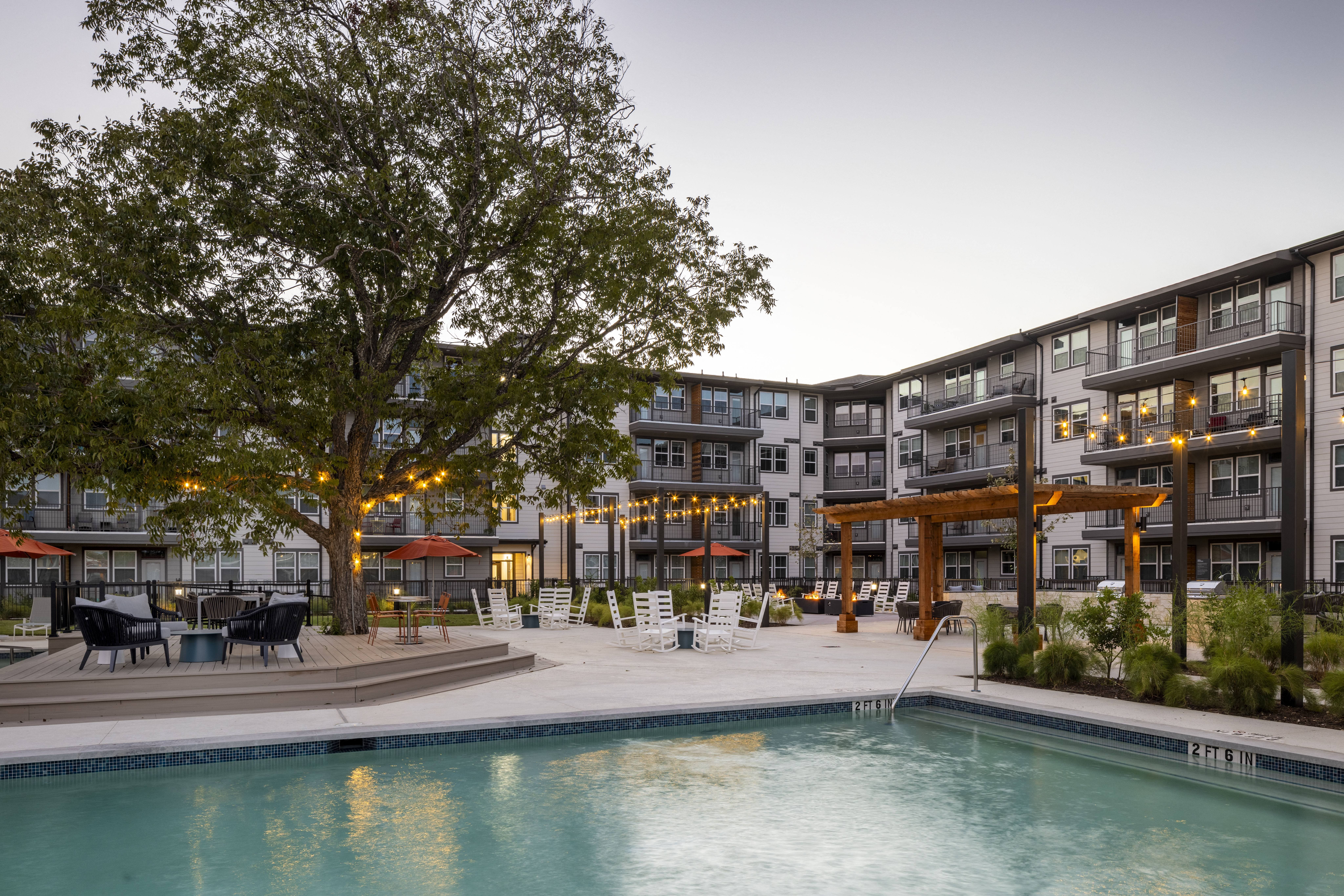 a resort-style swimming pool and courtyard at a senior apartment community